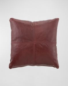 a brown leather pillow on a white background