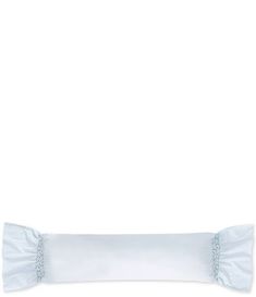 a white pillow with ruffles on the bottom and an eyelet at the top