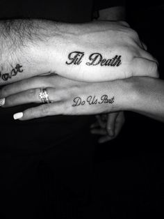 two people holding each other's hands with tattoos on their fingers and the words i love