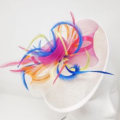 Vibrant,tropical, tuti- colours pale ivory hatinator with feathers ribbon and centre bead cluster.   Great for Mother of the bride, wedding guest or a day at the races. New Item Main Colours: Ivory,  lime green, cobalt blue and bright orange.  Material: Sinnamay hat, crinoline, synthetic beads and feathers,. Comes with all 3 interchangeable attachments, clip, comb and Alice band This design can be made in other colours, so please feel free to ask if you have another colour in mind, we may be abl Orange Summer Headpieces For Races, Spring Races Orange Fascinator, Orange Spring Evening Fascinator, Orange And Pink Fascinator, Elegant Multicolor Hat-style Headpiece, Alice Band, Tropical Colors, Bright Orange, Comb