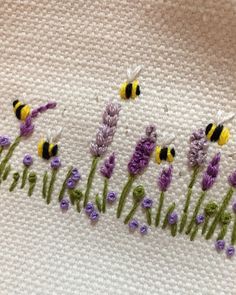 some purple and yellow flowers are on a white towel with the words lavender written in it