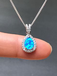 Sterling Silver White Blue Opal and CZ Necklace Bridal/Wedding Opal Necklace Metal: All Components Are Made From .925 Sterling Silver Stone: Lab created Opal and Cubic Zirconia Measurement: pendant height is 20mm including bail Choose Chain Length Please feel free to Convo me with any questions before purchasing. Please view policy before purchasing Other Opal Necklaces can be found here https://www.etsy.com/shop/LinksAndStones?ref=ss_profile&section_id=24284450 Thank You For Visiting My Sho Blue Teardrop Jewelry For Wedding, Blue Teardrop Wedding Jewelry, Sapphire Pendant Necklace For Wedding, Blue Teardrop Pendant Jewelry For Formal Occasions, Blue Teardrop Pendant For Formal Occasions, Blue Wedding Necklaces With Accent Stones, Blue Wedding Necklace With Accent Stones, Sparkling Drop Bridal Necklace, Blue Birthstone Necklace For Wedding