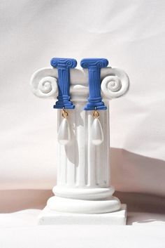 Unique earrings inspired by the architectural beauty of Ancient Greece. Bold and statement earrings for history and art lovers.  Size 2.6 x 4.4 x 0.10 cm + the renaissance pearl  If you are into a more minimal look, please check our white column earrings: https://treasurehuntstudioco.etsy.com/listing/1208279701/greek-column-clay-earrings-ancient ▫️ DETAILS ▫️ -Lightweight polymer clay. -Renaissance pearl.  -All posts & backings are gold plated or surgical stainless steel which makes each earring Greek Vases For Kids Clay, Roman Earrings, Roman Clay, Blue Pearl Earrings, Greek Columns, Greek Blue, Greek Gifts, Blue Pearl, Travel Jewelry