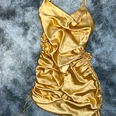 Gold Satin Spaghetti Strap Dress Size Small. Adjustable Length From Ankle Length To Mini Dress With Scrunchy Sides. Never Worn Gold Satin Mini Dress For Summer, Gold Mini Dress With Spaghetti Straps For Summer, Gold Spaghetti Strap Mini Dress For Date Night, Gold Mini Dress With Spaghetti Straps For Date Night, Ruched Cami Mini Dress For Party, Gold Sleeveless Ruched Mini Dress, Party Cami Dress With Ruched Details, Gold Spaghetti Strap Dress For Summer, Gold Spaghetti Strap Summer Dress