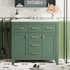 a bathroom with green cabinets and white counter tops