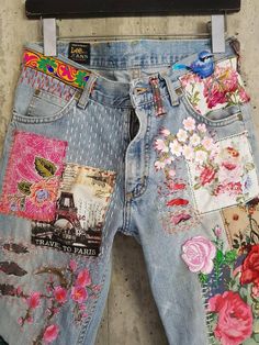 the jeans are decorated with flowers and birds