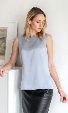 Meet the perfect silk shell top. This elevated silk tank can be worn alone or under your favorite blazer – you'll look equally fabulous either way. Elegant and classy with a versatile and minimalist silhouette. Wear on its own or pair with a blazer. Minimalist gold button and keyhole closure on the back. Hits just below the hips with side slits. Great tucked or untucked. 100% ULTRA-PREMIUM SATIN CHARMEUSE SILK – Washable Formal Silk Tank Top For Summer, Elegant Fitted Tank Top For Summer, Elegant Fitted Summer Tank Top, Elegant Silk Tank Top, Silk Tank Top For Spring Evenings, Elegant Silk Sleeveless Blouse Tops, Elegant Silk Sleeveless Blouse, Elegant Sleeveless Silk Blouse, Elegant Tank Top For Spring