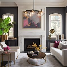 a living room filled with furniture and a fire place in front of a painting on the wall