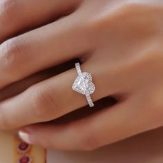 a woman's hand with a diamond ring on it