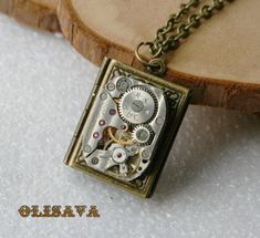 "Steampunk Jewelry - pendant with Antique Mechanical Jeweled Watch Movement , book  pendant . Here is a  steampunk book style bronze plated locket necklace . The locket opens out to reveal two sections for photos.  The size is book pendant  3/4\" X  7/8 \" and it has a 21\" bronze plated  chain . More Steampunk jewelry are here: https://www.etsy.com/shop/Olisava?section_id=14708491" Punk Journal, Steampunk Book, Book Pendant, Steampunk Accessories, Book Style, Steampunk Jewelry, Jewelry Pendant, Watch Movement, Locket Necklace