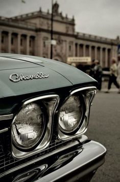 an old car is parked on the street