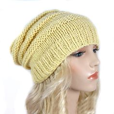 a mannequin head wearing a yellow knitted hat on top of a wig