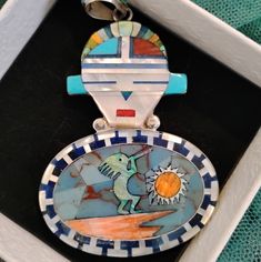 Dimensions: 3" By 2" By 1/5" Total Weight: 18.24 Grams One Side Shows A Beautiful Kachina Warrior The Other Side Shows A Zuni Kokopelli Playing To The Surface Motif. The Multiple Stones Consist Of Calico Lake Turquoise, Pink And Orange Coral, Sugilite, Jasper And Lapis. Inlaid In Sterling Silver. The Piece Is Marked S Sterling S. This Beautiful Pendant Showcases The Rich Cultural Heritage Of Native American Zuni Art. The Double-Sided Design Features Intricate Inlay Work With A Stunning Turquoise Stone. Crafted From High-Quality Sterling Silver, This Pendant Is A True Piece Of Jewelry. It Is Perfect For Those Who Appreciate The Unique And Authentic Designs Of Native American Artists. The Zuni Turquoise Jewelry, Jasper And Lapis, Wallpaper Earth, Native American Artists, Orange Coral, Meaningful Jewelry, Authentic Design, Cultural Heritage, Native American Jewelry