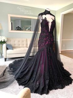 a black and purple wedding dress on display in a room with white carpeted flooring