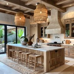 a large kitchen with wooden cabinets and stools