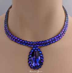 This necklace comfortable against the skin, it is not stiff or scratchy. It closes in the back with velcro.Heliotrope is a beautiful purple color with reflections of many shades. This is a simple design that will not compete with dress designs, but will fill in your neckline. The stones are not secured with any metal fittings so this will not snag your costume or your partners. The clear design will match any dress that you own because it has flesh tone background the only thing visible are the Purple Pendant Jewelry For Party, Purple Crystal Necklaces For Party, Purple Teardrop Pendant Necklace For Jewelry Making, Purple Teardrop Necklace For Jewelry Making, Purple Teardrop Necklaces For Jewelry Making, Purple Jeweled Necklace For Party, Purple Teardrop Pendant For Jewelry Making, Purple Teardrop Pendant Necklace For Formal Occasions, Purple Teardrop Necklace For Formal Occasions