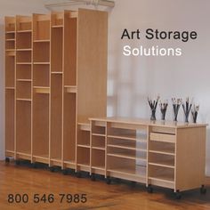 an empty room with shelves, drawers and other items on the floor in front of a sign that says art storage solutions