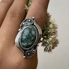 Handmade sterling silver ring with natural moss agate stone. Green gemstone ring in filigree technique and vintage style. Artisan jewelry made in Armenia by the Shahinian family. The ring`s band is adjustable and comfortable both to wear and give as a gift to those who don`t know the exact size of the finger. This ring is the perfect gift idea also for the ones who love unique, modern, and high-quality jewelry. ⦿We can also make matching earrings, pendants, and bracelets. For more details, just Oval Moss Agate Gemstone Ring, Green Moss Agate Ring Jewelry, Handmade Silver Rings With Moss Agate, Handmade Silver Moss Agate Rings, Elegant Moss Agate Ring With Natural Stones, Handmade Oval Moss Agate Ring, Oval Jade Ring With Natural Stones, Bohemian Emerald Ring With Natural Stones, Bohemian Green Oval Cabochon Ring