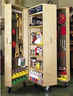 an open cabinet with tools on wheels in a room filled with other items and people