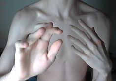 a shirtless man with his hands on his chest