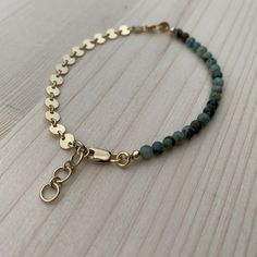 "This bracelet is super lightweight and delicate, but packs a big punch for being so petite. I love that it is a combo of smooth, subtle beads and bold, eye catching chain! The best of both worlds. Perfect for stacking up with other bracelets, or wearing alone. The high low bracelet is made from African turquoise beads, and either 14k gold fill or sterling silver coin chain and components. Since this is a handmade item, please allow for slight variations in your bracelet from those that you see Adjustable Bohemian Bracelet With Delicate Chain, Green Bracelet With Adjustable Chain, Green Bracelets With Adjustable Chain, Green Minimalist Bracelet With Jubilee Design, Dainty Nickel-free 14k Gold-filled Bracelets, Dainty 14k Gold-filled Nickel-free Bracelet, Dainty 14k Gold Filled Nickel-free Bracelet, Elegant Turquoise Bracelets With Adjustable Chain, Elegant Turquoise Bracelet With Adjustable Chain