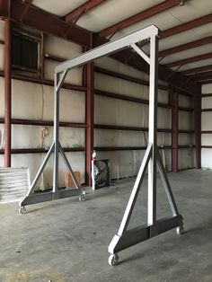 an empty garage with two metal frames in the center and one standing upright on it's side