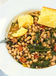 a white bowl filled with beans and cornbreads