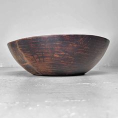 a wooden bowl sitting on top of a table