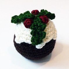 a crocheted pot holder with red and white flowers on it's top