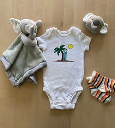 Your little surfer will be stoked to be seen in this gnarly Surf's Up Onesie®! Our adorably decorated baby bodysuits are perfect for your baby's social life from lounging at home, visiting grandparents or cruising in the neighborhood or park.  The design on the bodysuit is handmade with care and attention to detail. We use Gerber® brand onesies which are incredibly soft and made from 100% cotton. We recommend ordering one size larger.  Your bodysuit arrives beautifully packaged and is the perfec Playful Summer Onesie For Gifts, Summer Beach Fitted Onesie, Cute Fitted Beach Onesie, Playful Spring Beach Onesie, Summer Beach Printed Onesie, Summer Onesies, Perfect Baby Shower, Welcome Gifts, Gender Neutral Baby Clothes