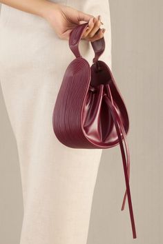 Wine corded bucket bag in faux leather with corded handle detail.
Composition: 100% PU/Faux Leather
Color: Wine
Other Details: 
Dimensions (in inches):
L x W x D: 6.5 x 3.5 x 7.5
Handle drop: 3.5
Closure: Adjustable drawcord - Aza Fashions Faux Leather Bag Diy, Classy Purses, Favorite Purse, Christmas Ornaments Diy, Handbag Essentials, Scrap Fabric, Buy Wine, Fabric Christmas Ornaments, Beautiful Handbags