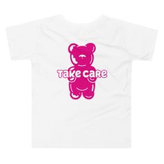 Part of our 'Fun Farewell Tee's' collection, where the graphic is printed on the back of the tee, and shares a quirky good-bye pun. The front of the t-shirt is blank. This delightful 'Take Care Gummy Bear' kids' tee, spreads sweetness and kindness wherever it goes! Adorned with a cute gummy bear illustration on the back of the tee with the heartfelt message 'Take Care'. Crafted with soft 100% cotton, it ensures your little one stays comfortable during all their adventures. Whether they're off to school, playdates, or simply lounging at home, this tee is a perfect blend of comfort and charm.  * 100% combed and ring-spun cotton * Fabric weight: 4.2 oz/yd² (142 g/m²) * Relaxed fit for extra comfort * Side-seamed construction * Pre-shrunk fabric * Blank product sourced from the US or Honduras Funny Pink T-shirt With Text Print, Playful Pink T-shirt With Slogan, Cute Funny Print T-shirt For Streetwear, Cute T-shirt With Funny Print For Streetwear, Playful Slogan Crew Neck T-shirt, Playful Slogan T-shirt With Crew Neck, Funny White T-shirt With Logo Print, Funny Pink T-shirt With Slogan, Fun Short Sleeve T-shirt With Logo Print