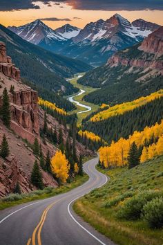 a winding road in the mountains with yellow trees