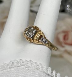 Two Tone Yellow & White Gold Diamond Antique Ring Size 6.75 This is a lovely estate find Art Deco Antique 14k white & yellow gold white diamond filigree ring. The ring is stamped 14k, and is 8mm NS and 4mm off the finger. The approximately 1.5mm full round white diamond has great shine. Notice the fine detailed geometric and floral filigree all the way around this beautiful ring. There is a small makers engraving of "sselton". This ring can be sized, please email for more info. This ring is in g White Diamond Ring Stamped 14k, Victorian White Diamond Ring With Prong Setting, Antique White Diamond Ring In 14k Gold, Vintage Gold Diamond Ring With Accents, Art Deco Gold Diamond Ring With Diamond Accents, White Diamond Ring Stamped 14k Round Cut, Antique Wedding Ring With Diamond Accents, Vintage Yellow Gold Wedding Rings With Diamond Accents, Art Deco Gold Diamond Ring With Accents