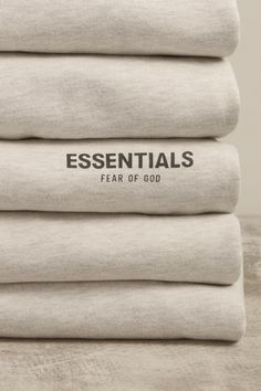 five linens stacked on top of each other with the words essentials printed on them