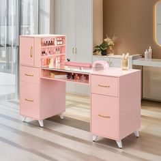 a pink desk with drawers and makeup on it