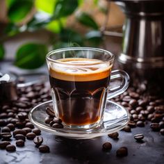 a glass cup filled with liquid surrounded by coffee beans