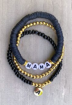 "Mama Bracelet 🖤🖤 Simple, chic Mama bracelet, looks cute with any attire!  Made with black clay beads beads, 18k gold accents and gold circle letters that read \"Mama\" Gold bracelet and accents on bracelets are 18k gold filled  If you would like another word or color, please put in Personalization Section* and we will contact you if we have questions.  CARING TIPS FOR YOUR JEWELRY ⭐️Treat and store with care. ⭐️ For longevity, avoid exposing your jewelry to water. ⭐️ Avoid having direct contact with lotions, perfumes, sanitizers as these chemicals may cause discoloration of your jewelry." Heishi Bracelet Ideas Sports, Black And Gold Clay Bead Bracelet, Head Bracelet Ideas, Trendy Adjustable Bracelet With Black Beads, Adjustable Black Charm Bracelet For Parties, Adjustable Black Charm Bracelet For Party, Trendy Adjustable Beaded Bracelets With Black Beads, Trendy Black Charm Bracelet For Party, Trendy Adjustable Black Beads Bracelet