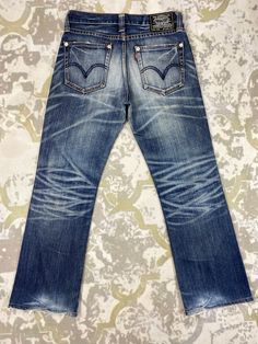 33X30 Distressed Blue Vintage Levi's 708 Jeans JN 1936 Size: 33 Actual measurement (inches): Waist - 33 Front Rise - 9.5 Hips - 40 Thigh - 11.5 Knee - 7.5 Leg Opening - 18 Inseam - 30 Outseam - 40.5 Material : Cotton  *Disclaimer: Product color may slightly vary due to photographic lighting sources or your monitor settings.  #JN1936 Classic Dark Wash Distressed Jeans, Classic Distressed Dark Wash Jeans, Distressed Indigo Denim Jeans, Classic Blue Distressed Jeans, Classic Distressed Denim Jeans, Classic Distressed Faded Jeans, Classic Faded Distressed Jeans, Vintage Straight Leg Stonewashed Jeans, Classic Distressed Faded Bottoms