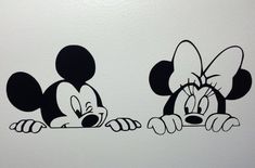 two mickey mouses sitting next to each other on a white wall with black outline