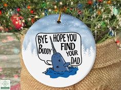 a christmas ornament hanging from a tree with a message saying bye hope you did't find your dad