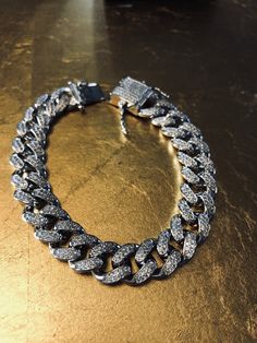 FAST SHIPPING!*TRUSTED SELLER**2300+ TRANSACTIONS* -Will be shipped through USPS with First Class Mail that includes tracking so you'll get it quick! -Don't confuse this with those cheap low quality cuban links that have glued in stones. -Premium 14k white gold OR yellow gold plated diamond cuban link Bracelet! -Plating is PVD which is the highest quality. -Stones are high quality VVS simulated lab diamonds(CZ)! Hand prong set and not glued in like the cheap ones! -Very nice box clasp! -12mm wid Luxury Cuban Link Bracelet With Bling, Luxury Bling Cuban Link Bracelets, Luxury Silver Cuban Link Chain Bracelet, Silver Tennis Bracelet With Round Chain, Silver Cubic Zirconia Chain Tennis Bracelet, White Gold Iced Out Cuban Link Jewelry, Iced Out White Gold Cuban Link Jewelry, White Gold Iced-out Cuban Link Jewelry, Diamond White Cuban Link Iced Out Jewelry