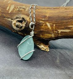 This delicate handcrafted seaglass pendant is made with a beautifully smoothed light teal blue nugget found in Kintyre on the west coast of Scotland. The glass is wrapped in 1mm 925 sterling  silver wire and is suspended from a hand-formed silver bail.   Choose your preferred chain length at checkout.      Other similar items available: Pendants: https://www.etsy.com/uk/shop/RockLobsterCrafts?ref=l2-shopheader-name&section_id=24274610 Bangles & bracelets:  https://www.etsy.com/uk/shop/RockLobste Round Sea Glass Jewelry Gift, Minimalist Handmade Necklace With Recycled Glass, Minimalist Handmade Necklaces With Recycled Glass, Sea Glass Round Necklace As Gift, Round Sea Glass Necklace As A Gift, Round Sea Glass Necklace For Gift, Minimalist Recycled Glass Jewelry For Gifts, Adjustable Wire Wrapped Necklace In Recycled Glass, Adjustable Wire Wrapped Necklaces In Recycled Glass