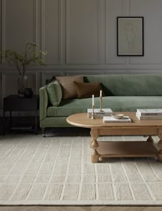 a living room with a green couch and coffee table