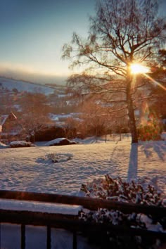 the sun shines brightly on snow covered ground