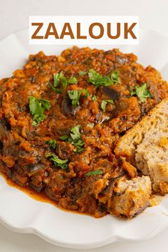 a white plate topped with meat covered in sauce