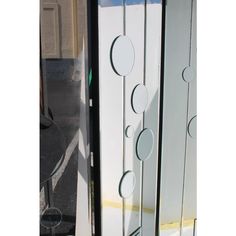 a tall glass door with circles on it