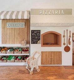 there is a toy pizza shop with lots of food on display in front of it