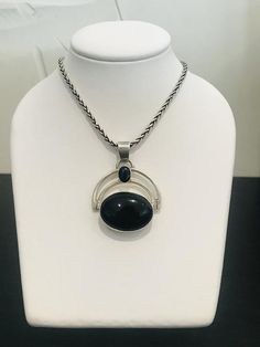 This black onyx pendant and chain is so versatile.  Will go with any outfit, casual or dressy.  Note the beautiful end tabs and clasp on the chain.  Beautifully made.  There is more than 32 grams of sterling solver between both the pendant and chain. Black Pendant Necklace With Silver Chain, Black Jewelry With Silver Chain And Round Pendant, Modern Black Jewelry With Silver Chain, Elegant Onyx Jewelry With Large Pendant, Modern Black Oval Pendant Necklace, Black Necklace With Silver Chain And Round Pendant, Black Sterling Silver Necklace With Large Pendant, Black Oval Jewelry With Large Pendant, Sterling Silver Necklace With Large Black Pendant