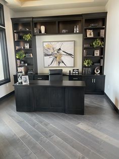 an empty office with wood floors and built - in bookcases